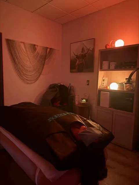 The NakedCat Beauty treatment room glowing in warm rose light